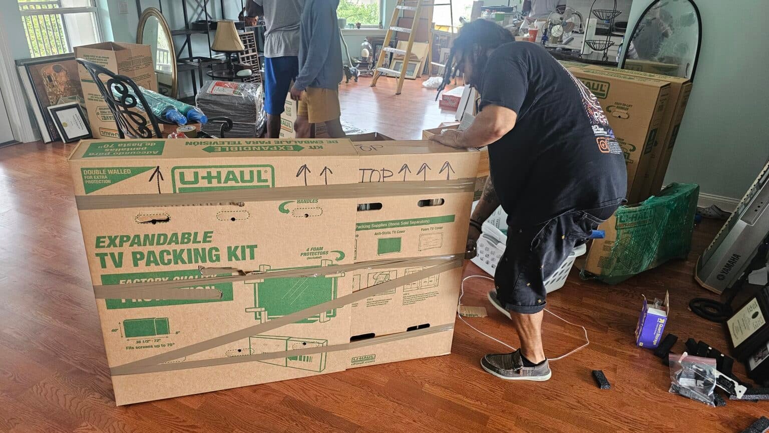 Many carrying a moving box. moving company in Jacksonville Beach