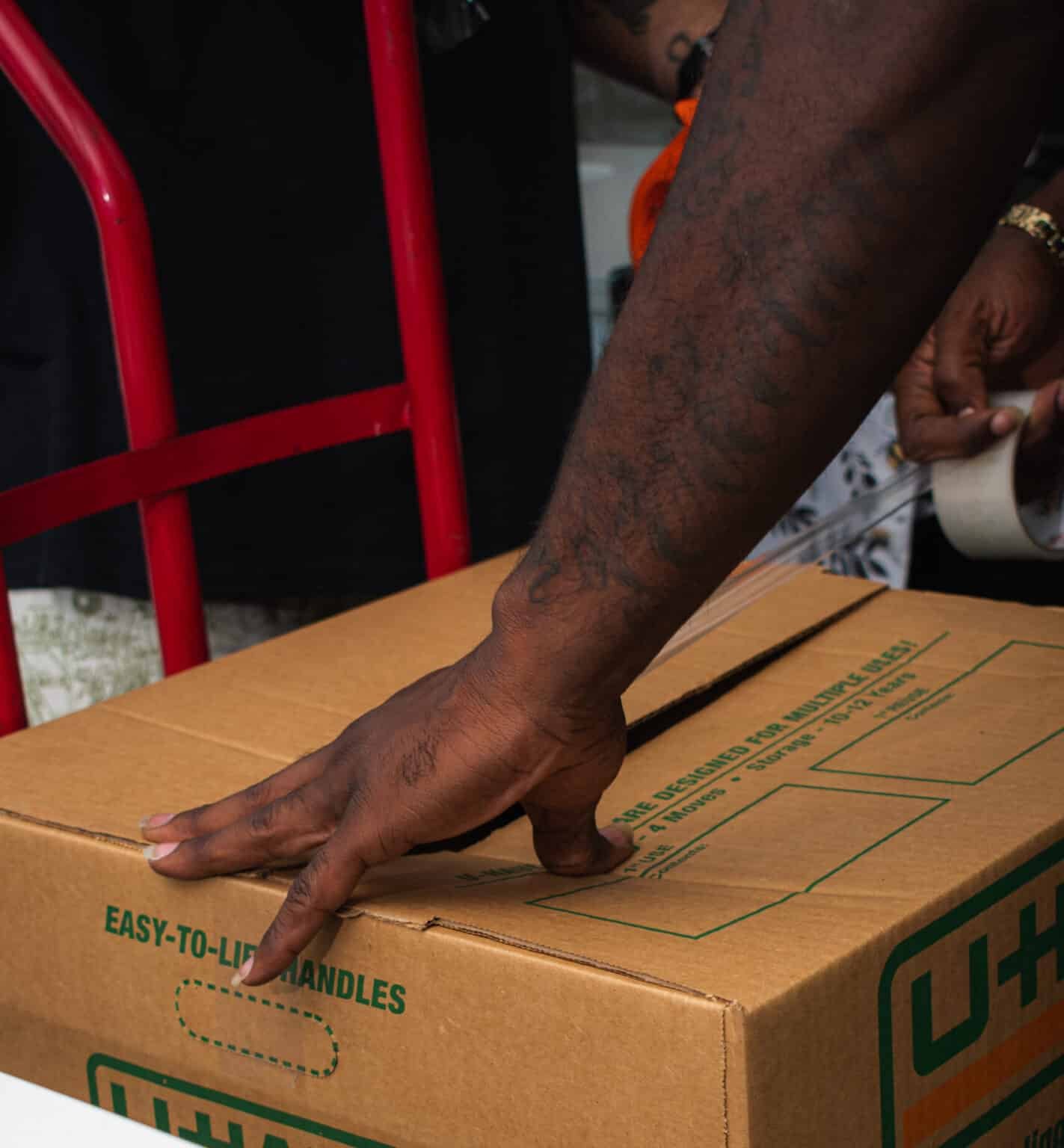 Man taping a box