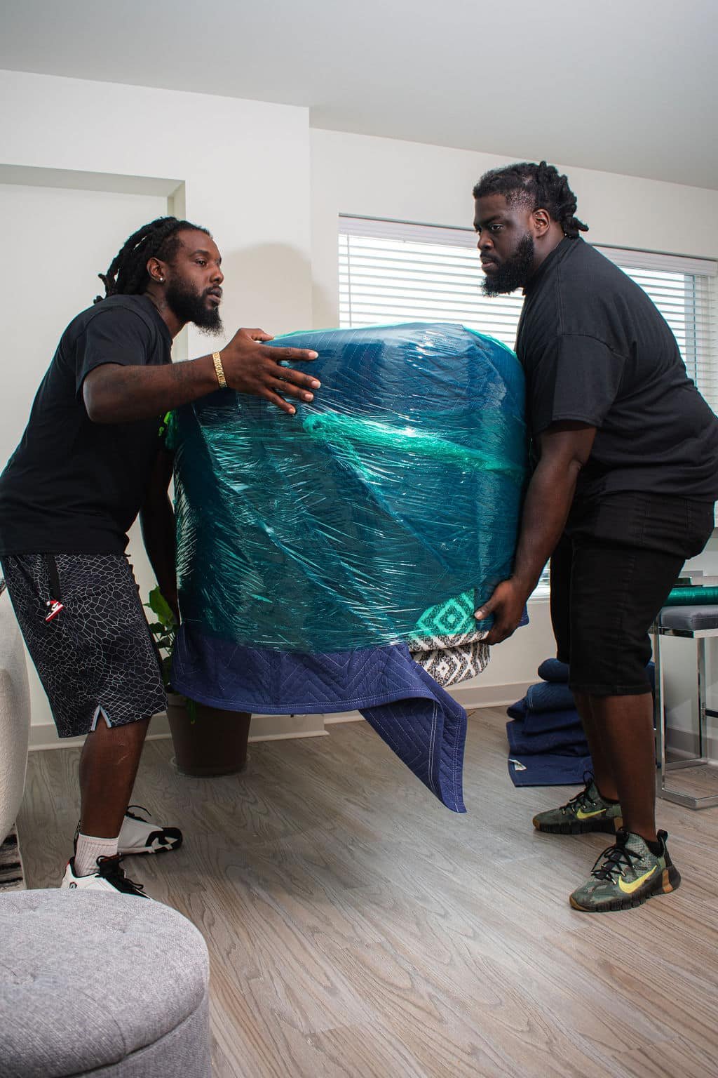 Two Pro Touch employees carrying a piece of furniture.