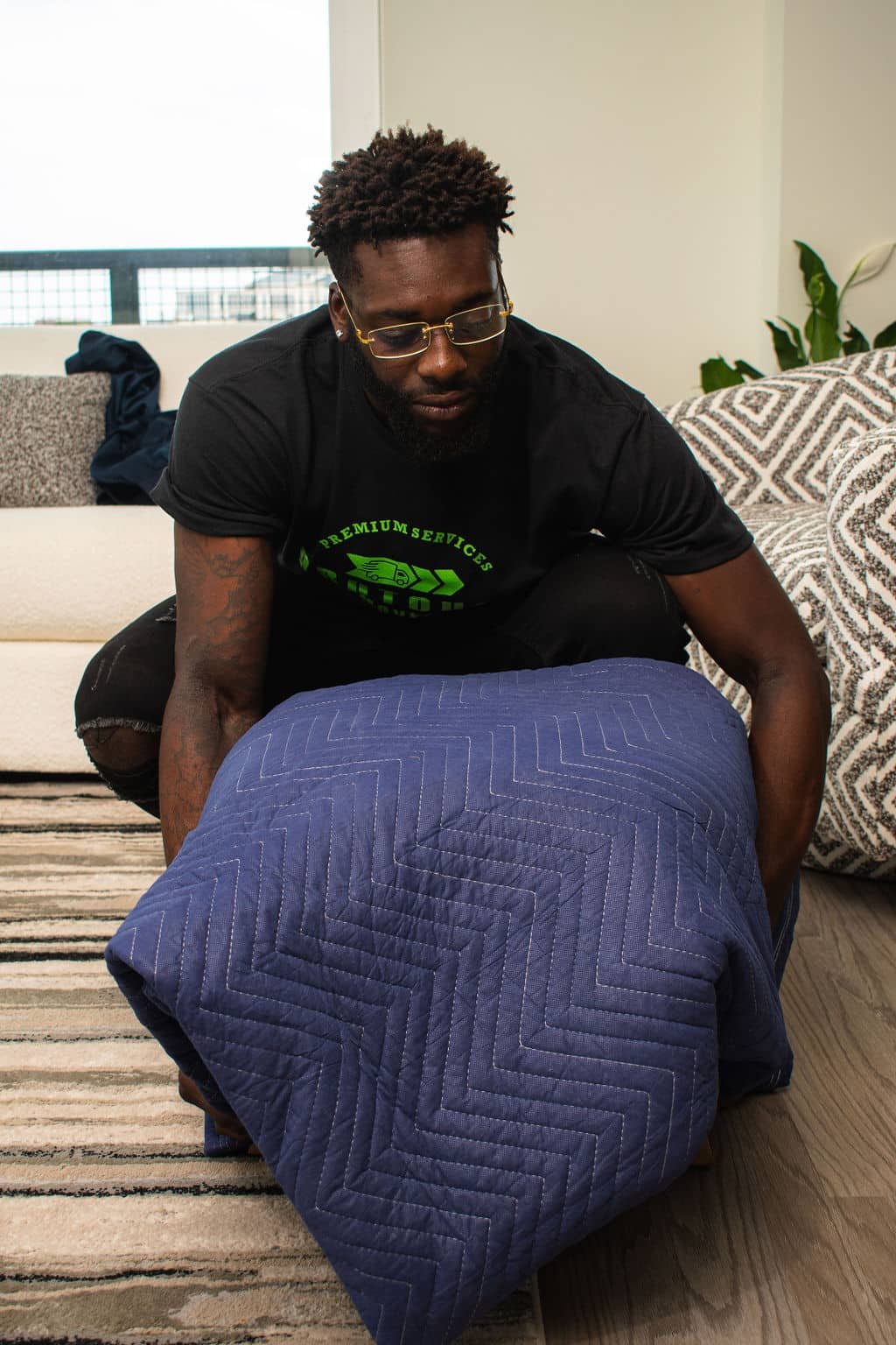 Pro Touch Movers employee gently picking up a wrapped item.