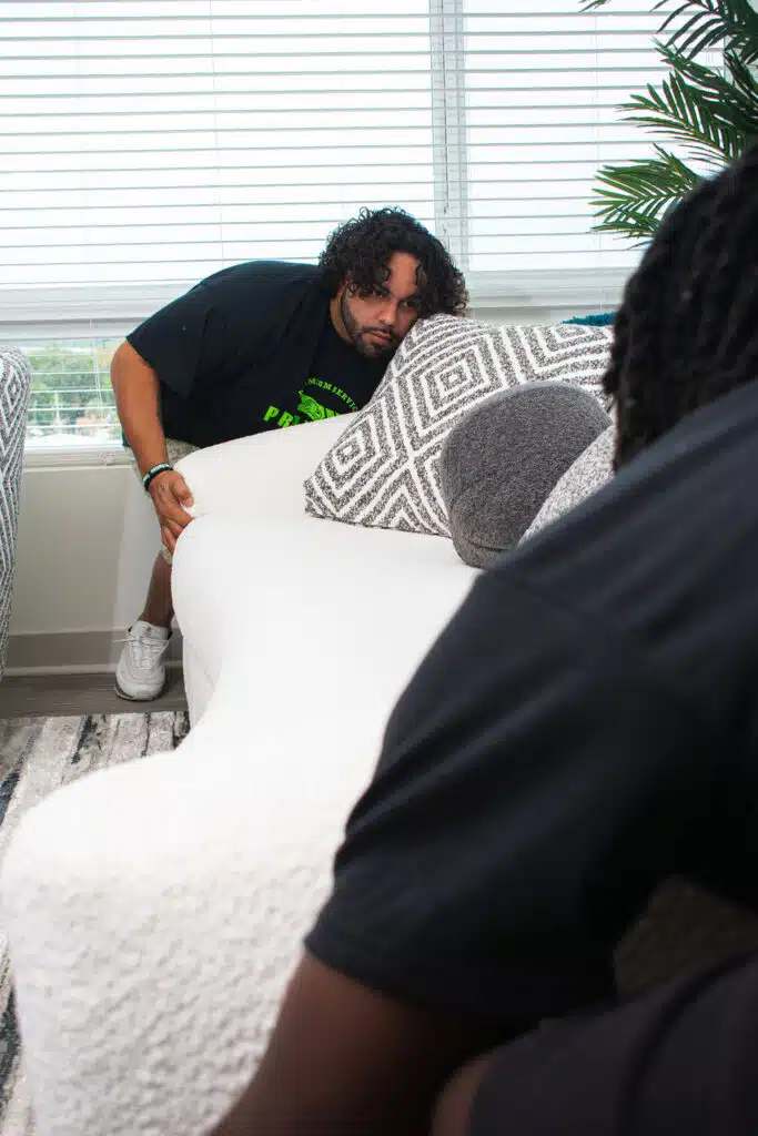 Services 24 Two pro touch movers workers positioning a couch