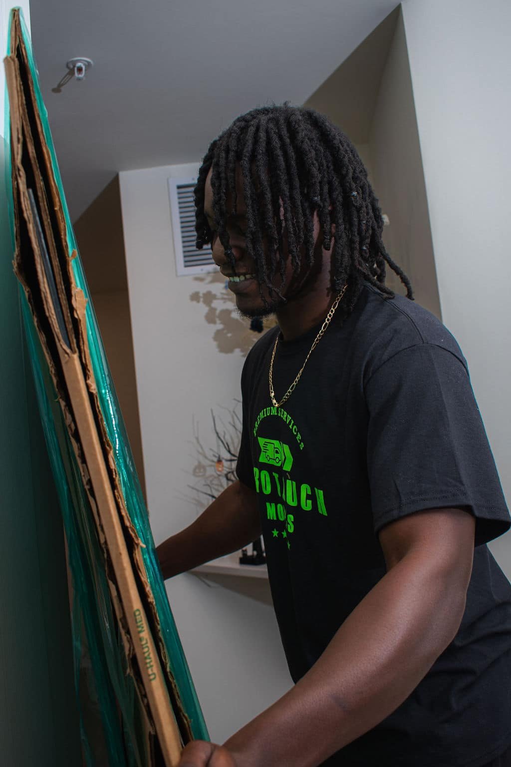 Person carrying large cardboard piece. moving company in Lakeland. Gainesville