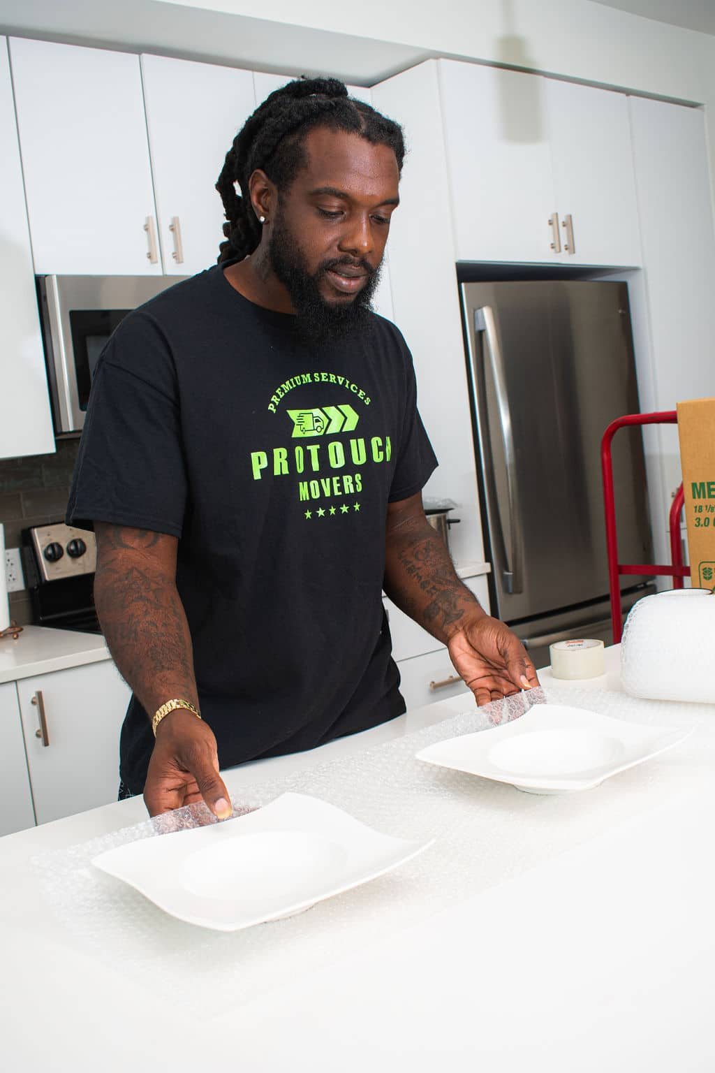 Senior moving services in Jacksonville. Bubble-wrapping plates.