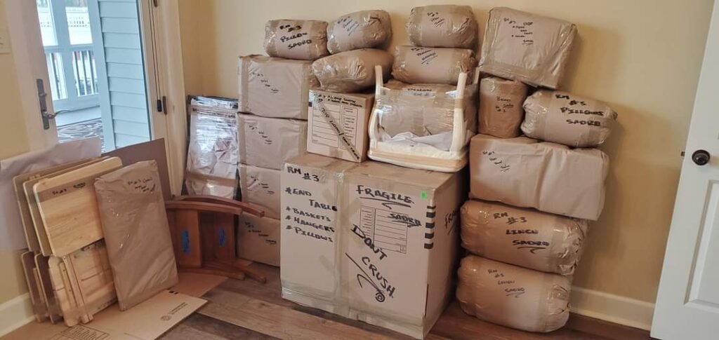 Home 12 Senior moving services in Jacksonville, FL. Stacks of secured boxes in a home.