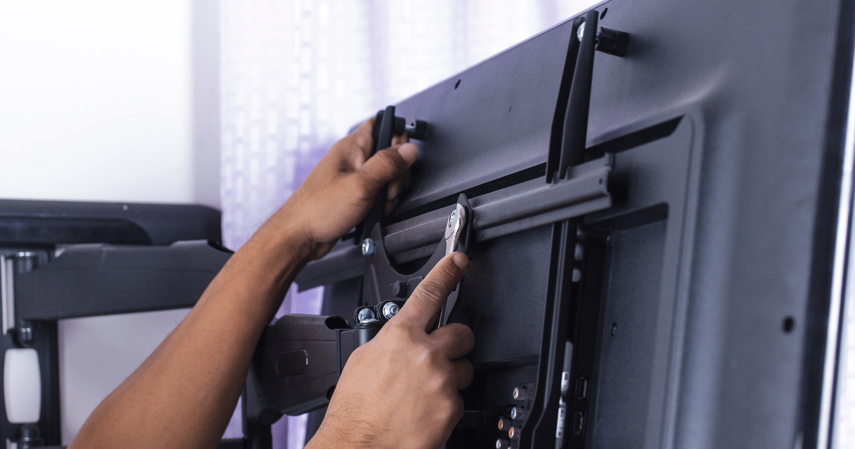 A TV being mounted by experts